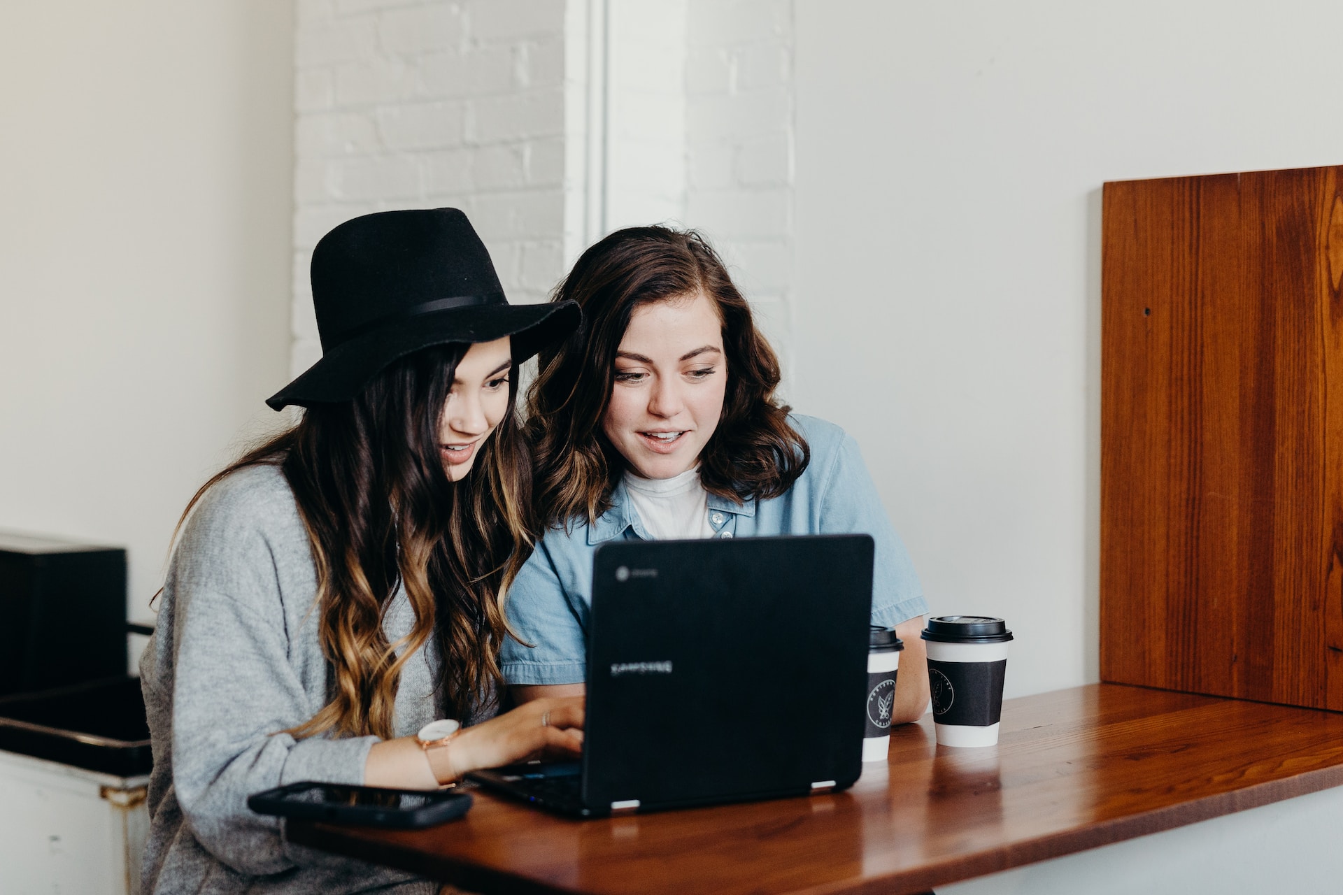 women looking at a laptop screen